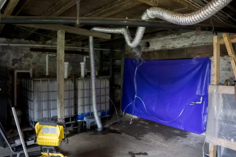 A biogas plant and a PVC storage bag in the basement of a house A biogas plant and a PVC storage bag in the basement of a house