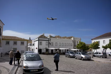 A plane flights over the old city centre of Faro, Portugal A plane flights over the old city centre of Faro, Portugal