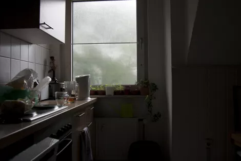 A kitchen with a view during a rainy day A kitchen with a view during a rainy day